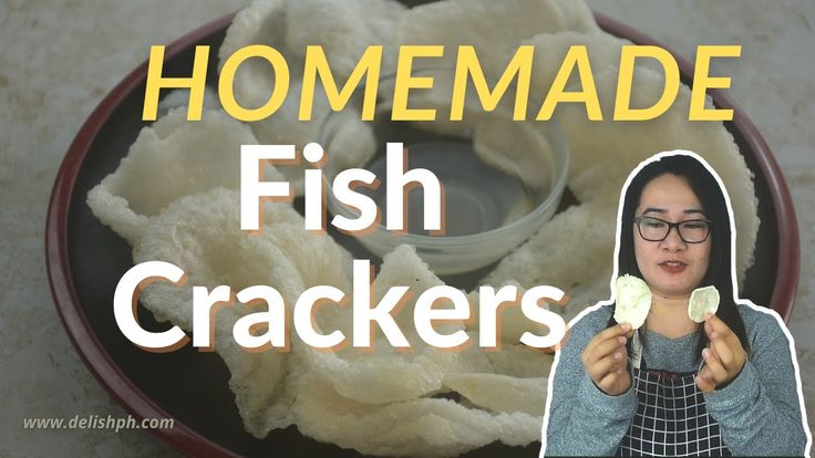 a woman holding two pieces of food in her hands and the words homemade fish crackers