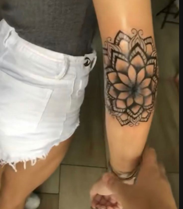 a woman with a tattoo on her leg