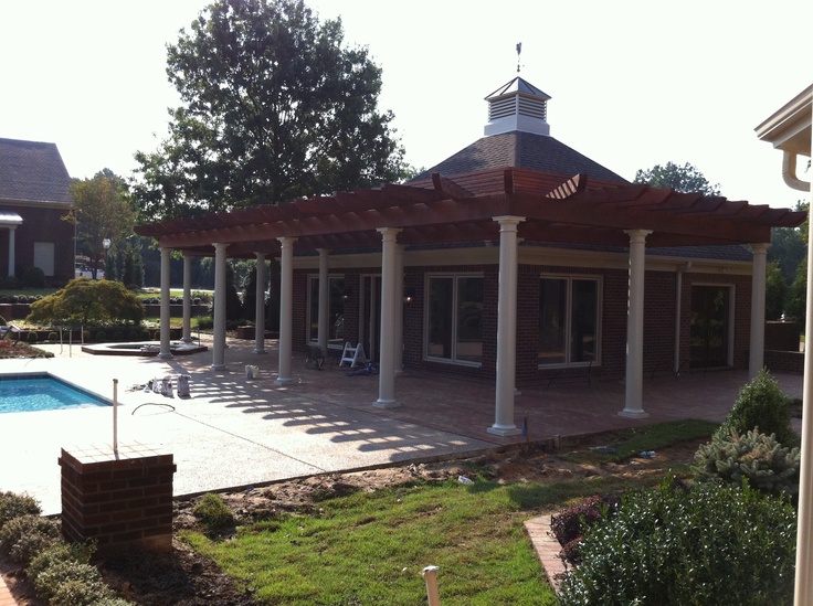 an outdoor pool and gazebo in the middle of a yard