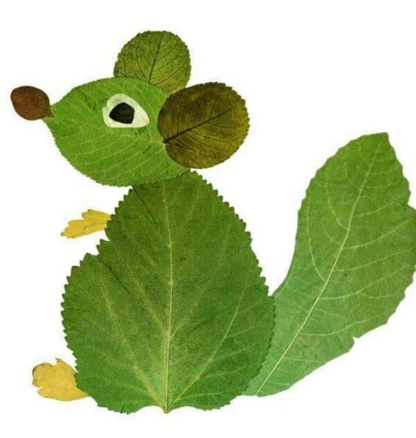 a green leaf with two leaves attached to it's back end, and an eyeball in the middle