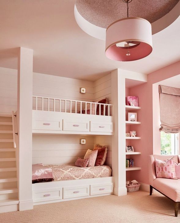 a bedroom with pink walls and white bunk beds