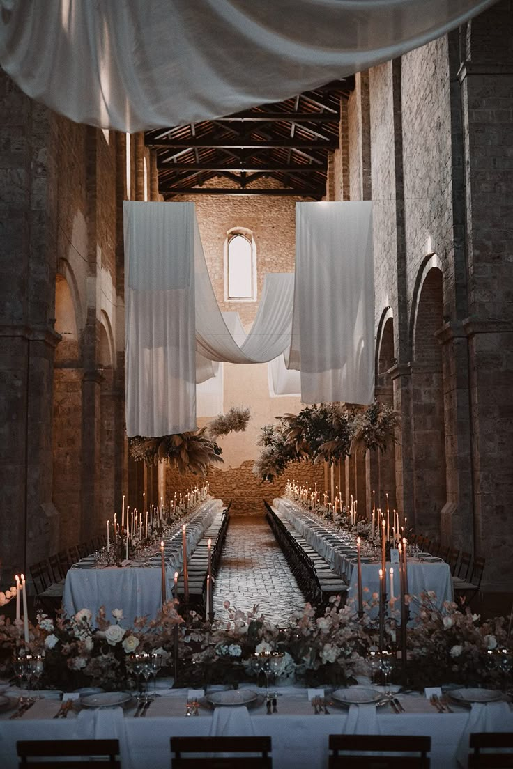 an indoor wedding setup with candles and flowers