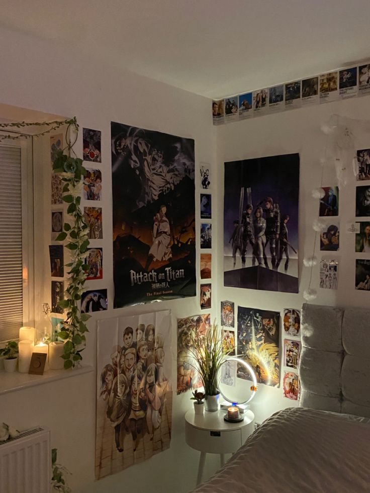 a bedroom with posters on the wall and a bed in front of it is lit by a candle