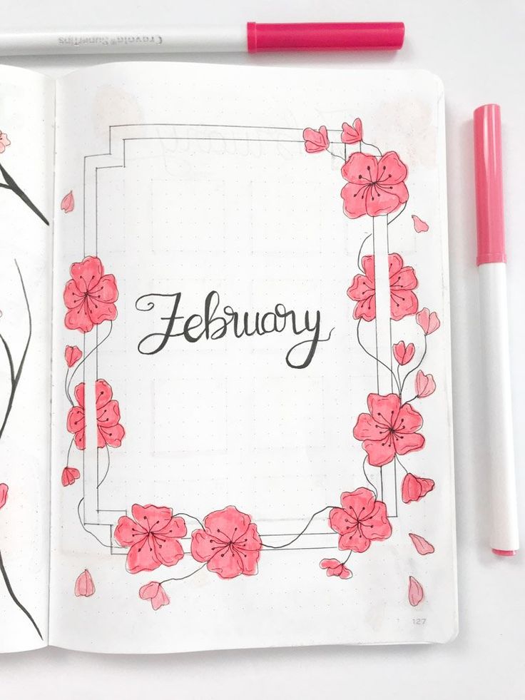 an open notebook with pink flowers and the word february written in black ink on it