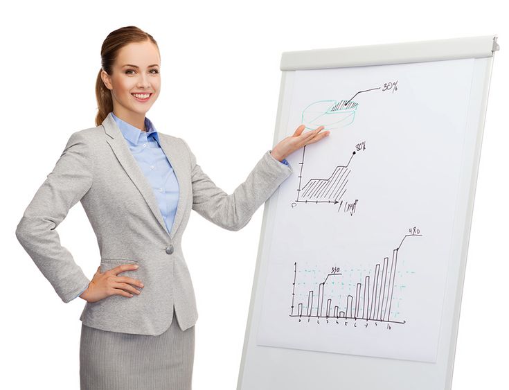 a woman standing in front of a whiteboard with diagrams on it and pointing to the side