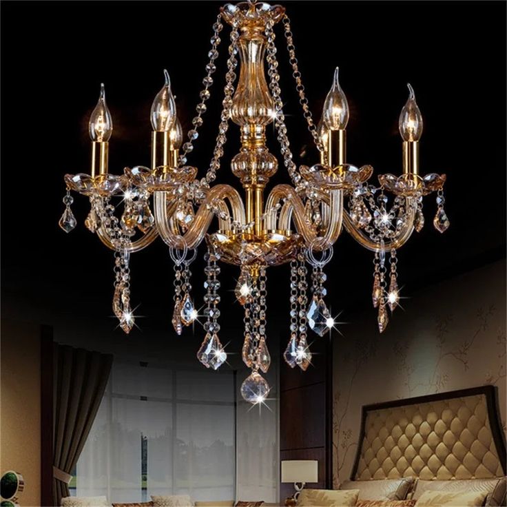 a chandelier hanging from the ceiling in a bedroom