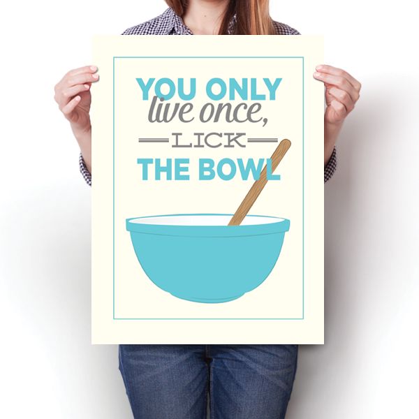 a woman holding up a poster that says you only live once, lick the bowl