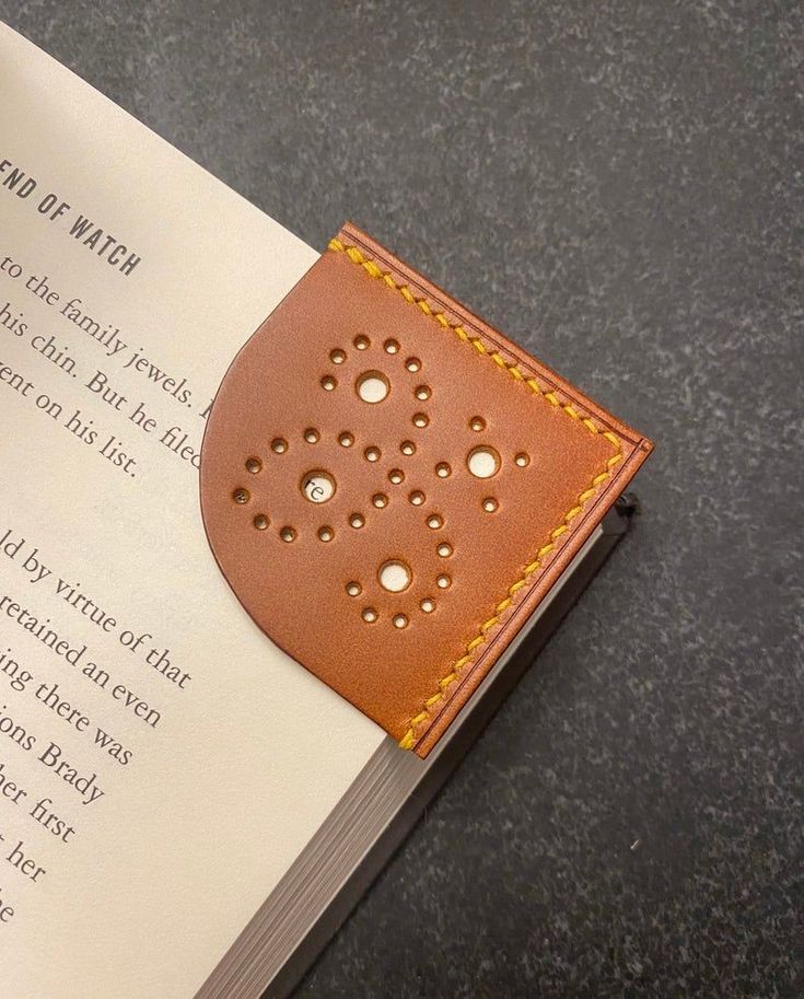 an open book with holes in it sitting on a table