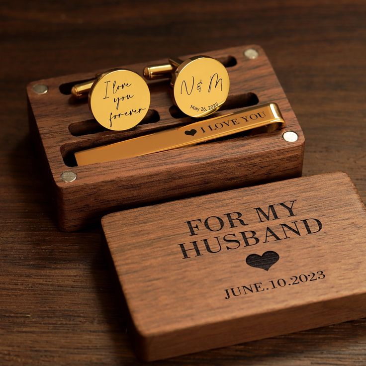 two personalized wooden cufflinks and tie bar in a box on a table