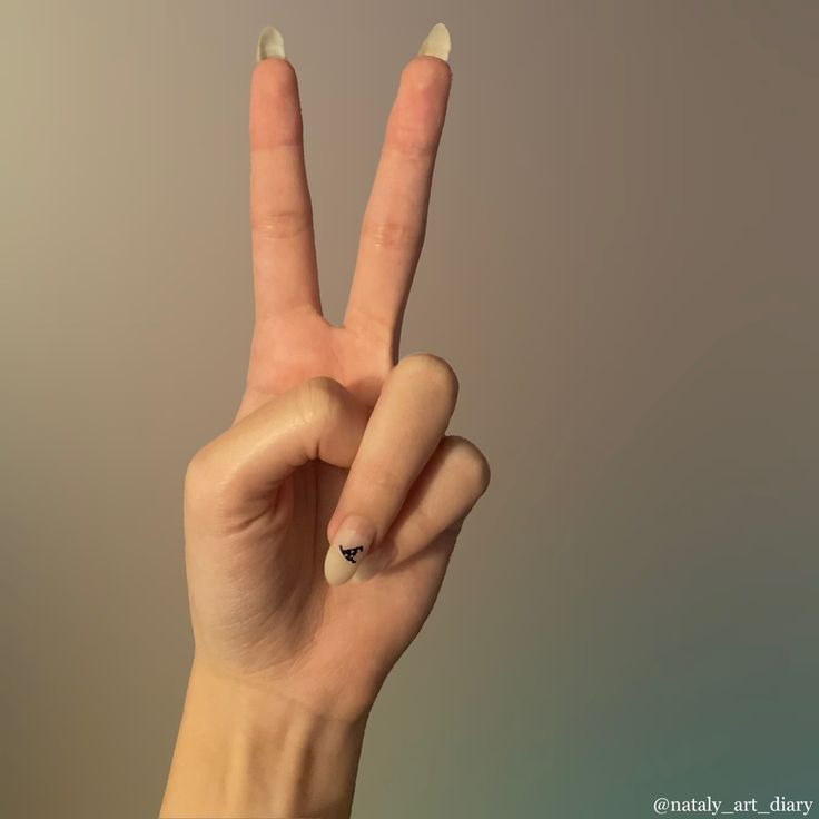 a woman's hand making the peace sign with her fingers