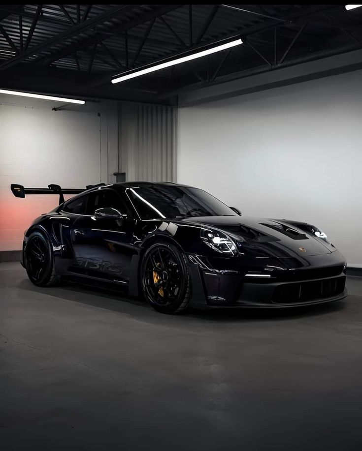 a black sports car parked in a garage