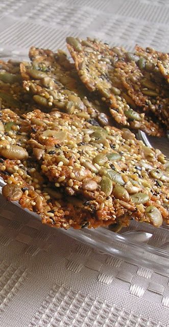 some food is in a glass dish on a white tablecloth and there are several pieces cut out