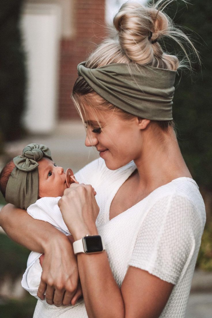 a woman holding a baby in her arms