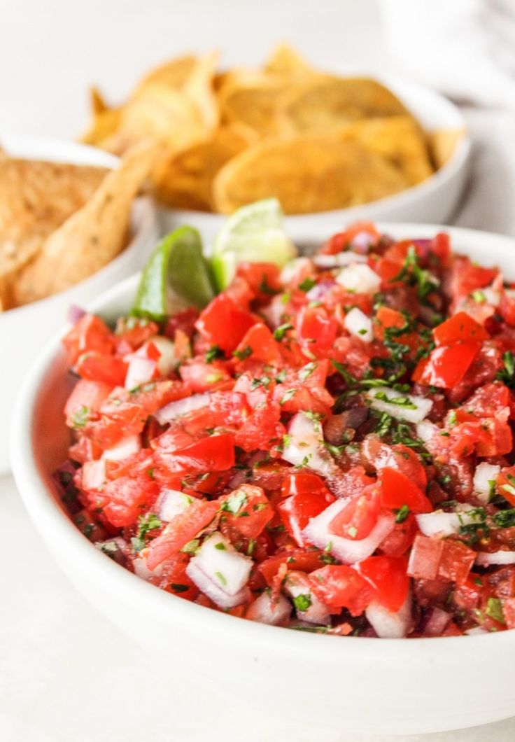 a white bowl filled with salsa next to tortilla chips