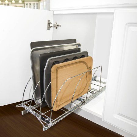 a metal dish rack with four plates on it in the corner of a kitchen area