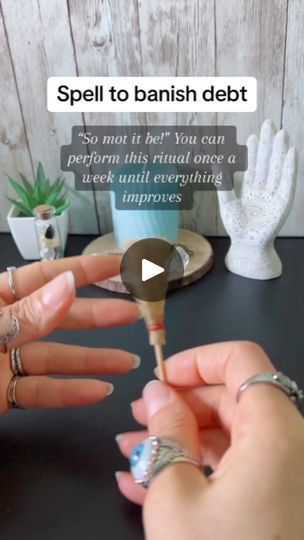 a woman is holding a spoon in her hand with the caption spell to banish debt