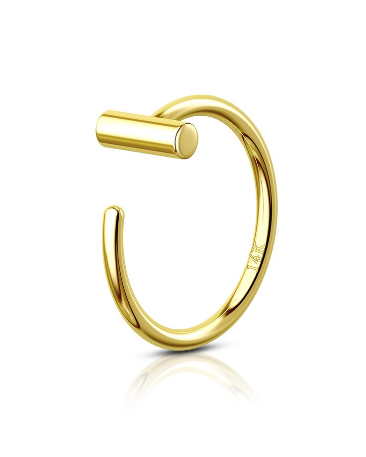 an open gold ring with the letter c in it's center, on a white background