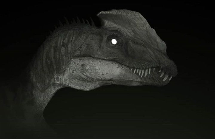 a close up of a dinosaur in the dark with its mouth open and glowing eyes