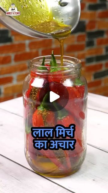 a person pouring liquid into a jar filled with fruit