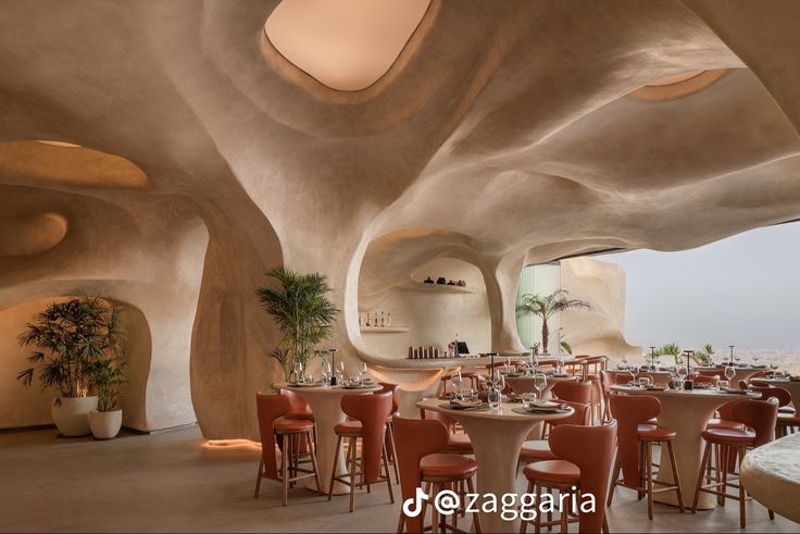 the interior of a restaurant with curved walls