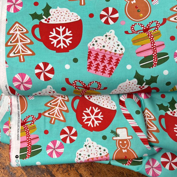 a close up of a cloth with christmas decorations on it and candy canes in the background