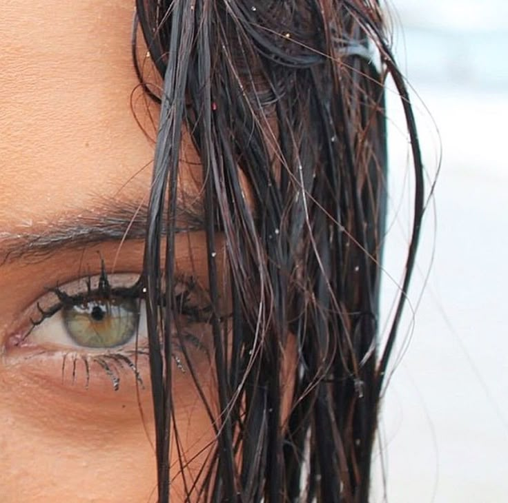 a close up of a person's face with wet hair on top of their head