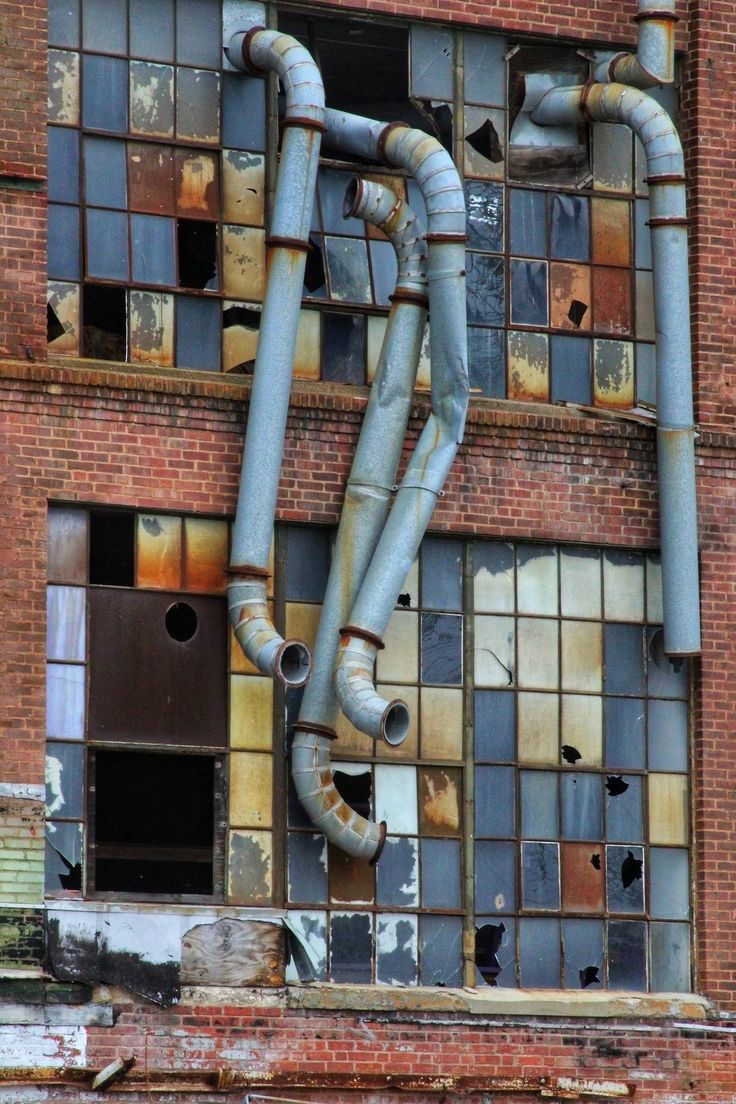 an old building with some pipes sticking out of it