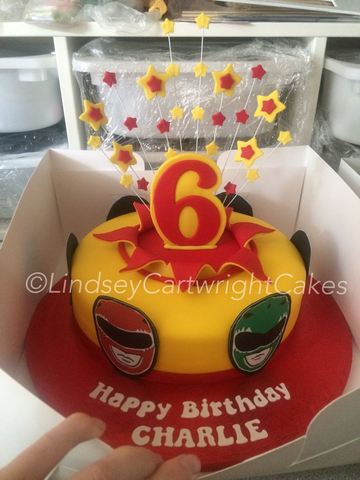 a birthday cake with the number six on it is in a box and ready to be eaten