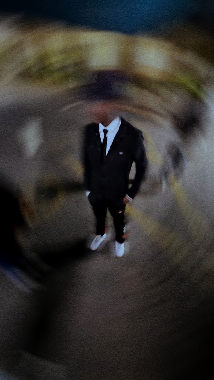 a blurry photo of a man in a suit and tie