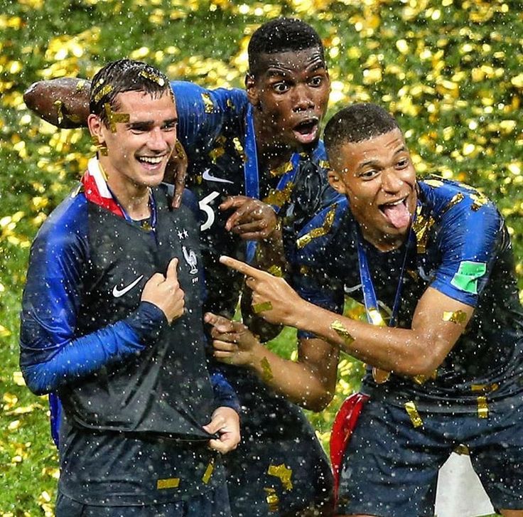 the soccer players are celebrating in the rain