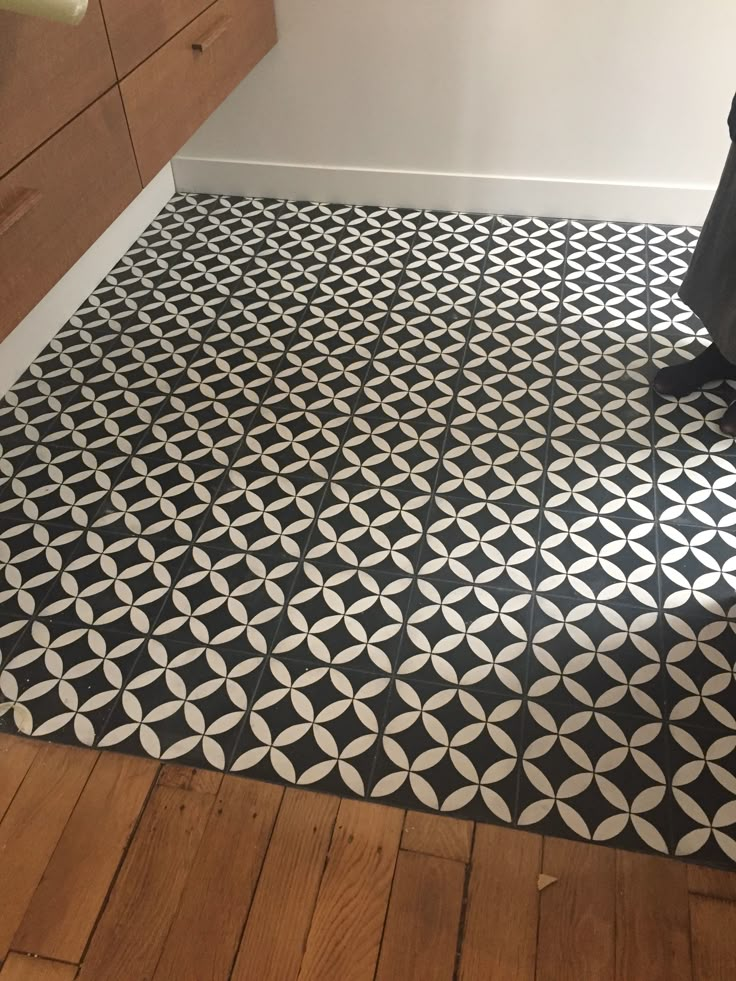 a black and white patterned floor in a bathroom