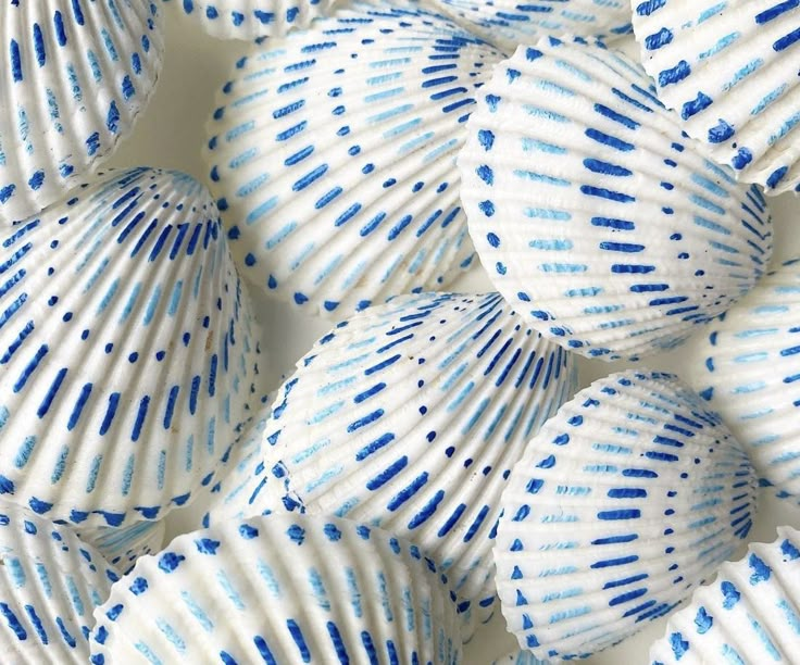 blue and white shells are arranged in a pattern on the surface, as if they were seashells