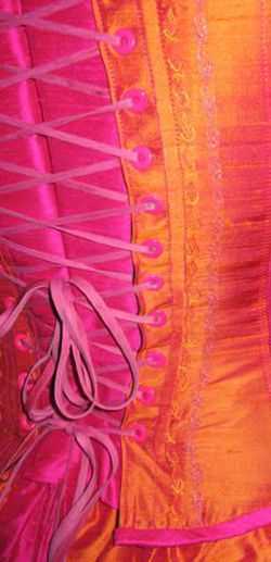 an orange and pink corset on display in a store