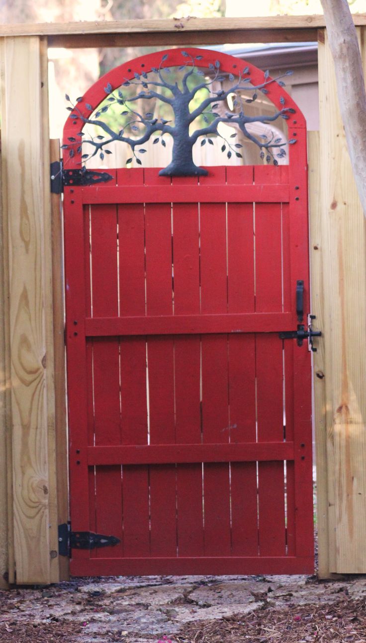 a red door with a tree on it