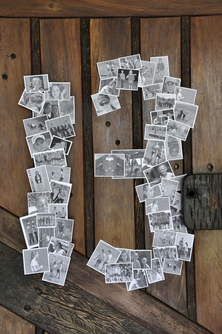 the letter d is made out of photos and pinned to a wooden door with magnets on it