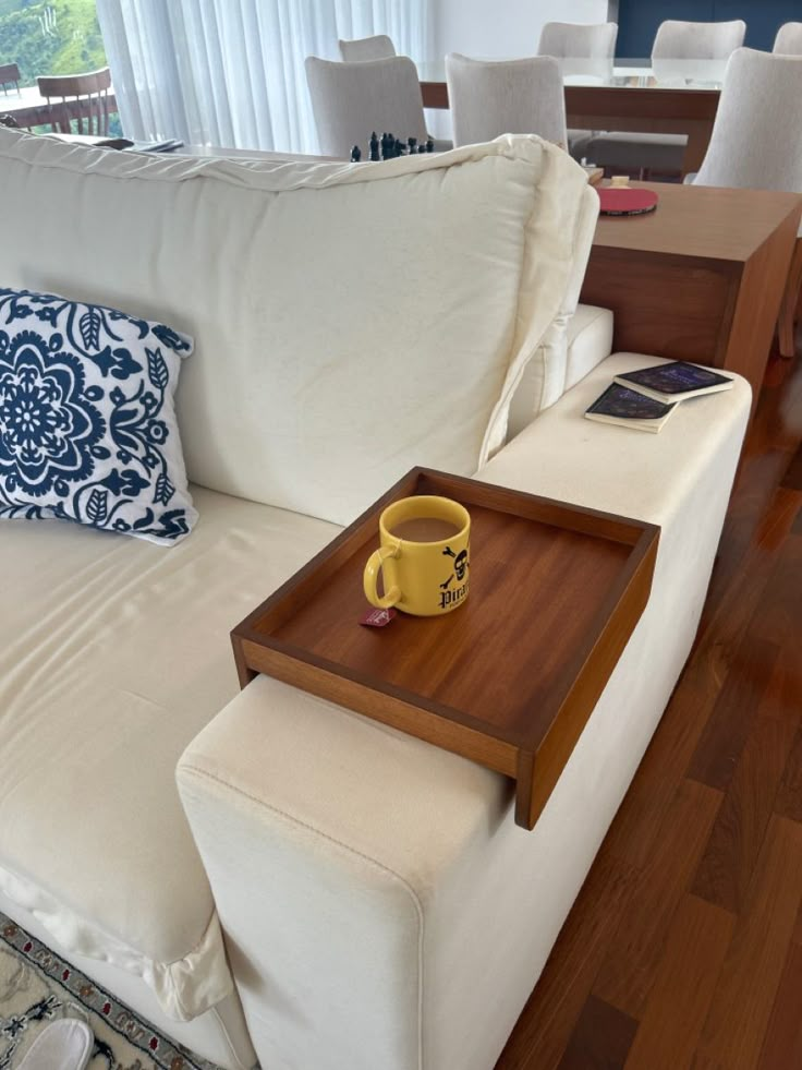 a coffee table with a tray on top of it in front of a white couch