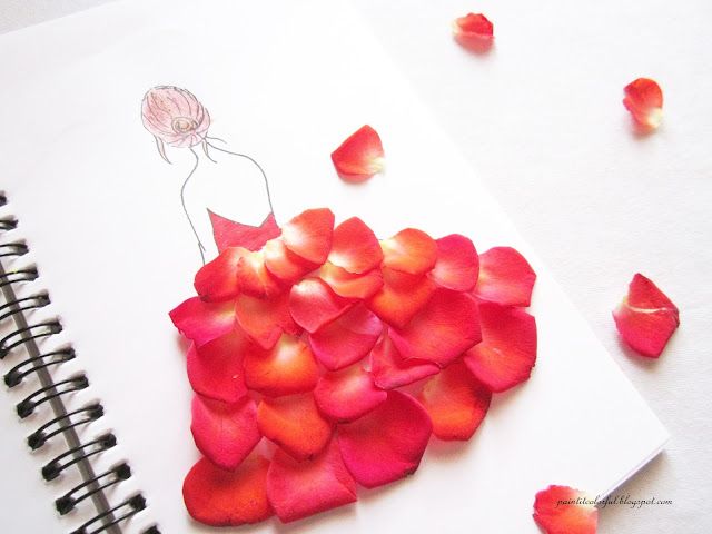 a drawing of a woman in a dress made out of rose petals on top of a spiral notebook