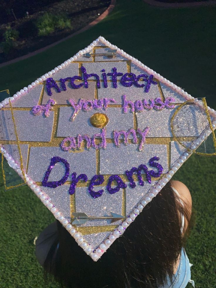 a woman wearing a graduation cap with writing on it