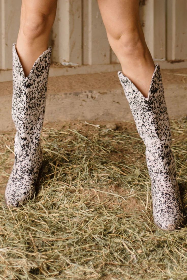 Get ready to moove and groove in these Round Em Up Boots! These wild cow print boots are unlike anything you've seen before with an iridescent pink tint that will have heads turning. So kick up your heels and make a statement in style. Yeehaw! Calf Width laid flat: 7.5" Material: Polyurethane Heel:2.5" Height: 14.5" Cow Print Boots, Cow Hide Shoes, Duster Dress, Western Handbags, Print Boots, Concealed Carry Purse, Western Graphic Tees, Boot Print, Western Shirts