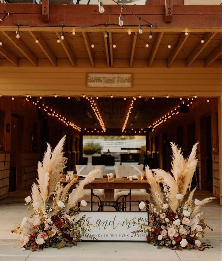 an entrance to a building with flowers and lights