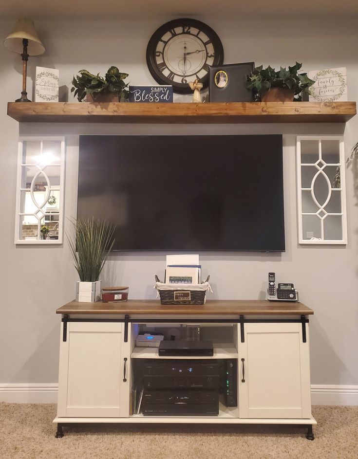 an entertainment center with a large clock above it