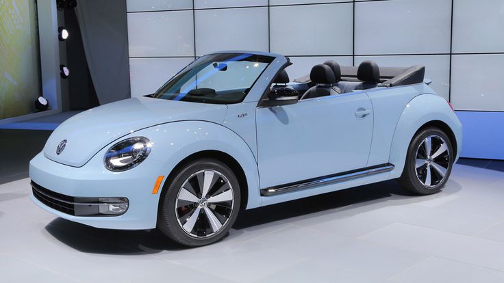 the volkswagen beetle convertible is on display at an auto show