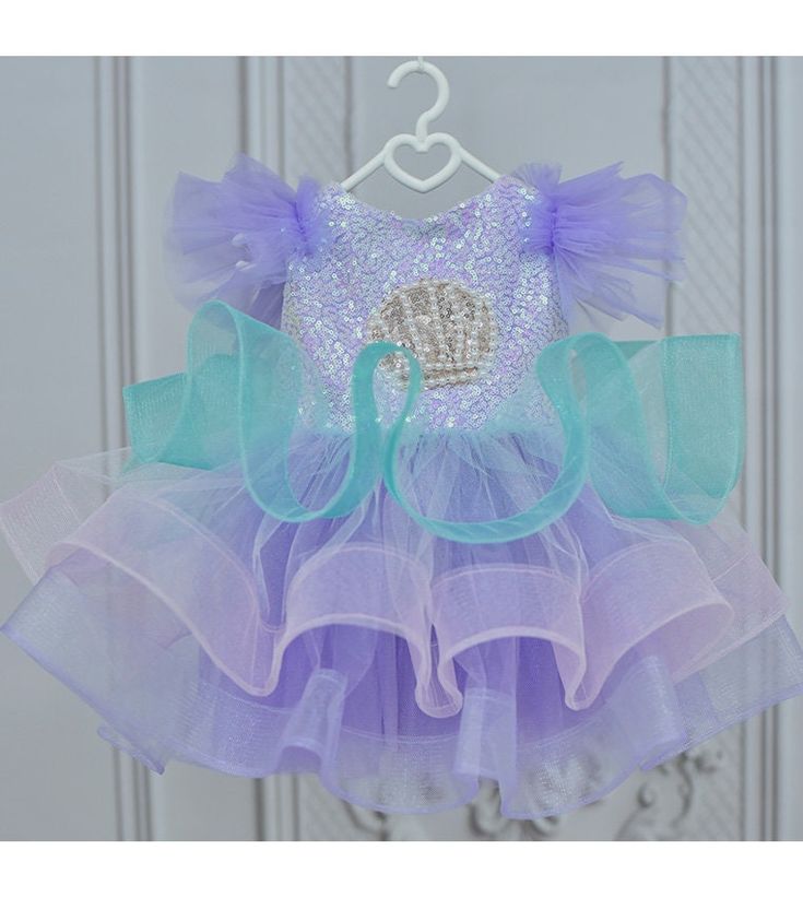 Dress your little one in the allure of the sea with our Mermaid Costume. This captivating outfit, featuring a mermaid tail tutu, is not just a Halloween costume; it's the ideal choice for birthdays and whimsical toddler adventures. Key Features: Charming mermaid costume designed for baby girls. Magical mermaid tail tutu for an enchanting underwater look. Versatile outfit perfect for birthdays, Halloween, and imaginative play. Crafted with attention to detail for a truly magical appearance. Comfo Purple Mermaid Tutu Dress For Dress-up, Tulle Mermaid Dress With Ruffles For Pageant, Blue Princess Mermaid Dress For Pageant, Princess Style Blue Mermaid Dress For Pageant, Pageant Mermaid Dress With Ruffles, Multicolor Princess Dress With Ruffles For Pageant, Multicolor Ruffled Princess Dress For Pageant, Pink Mermaid Dress With Ruffles For Pageant, Whimsical Purple Princess Dress With Ruffles