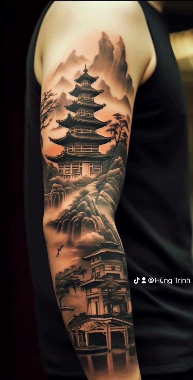 a man with a tattoo on his arm is standing in front of a mountain and pagoda