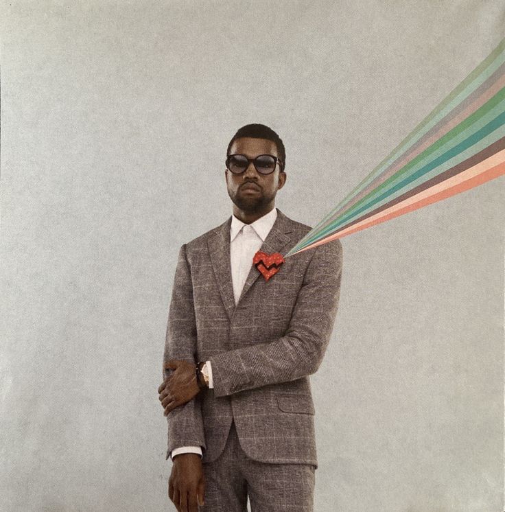 a man in a suit and tie with his arms crossed holding a multicolored object