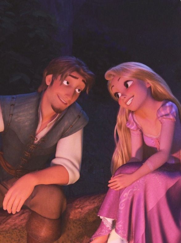 a man and woman dressed as disney characters sitting next to each other