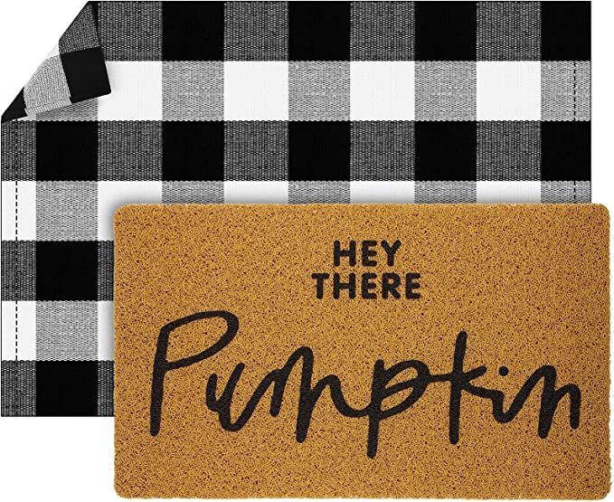 a door mat with the words hey there pumpkin on it and a black and white checkered background