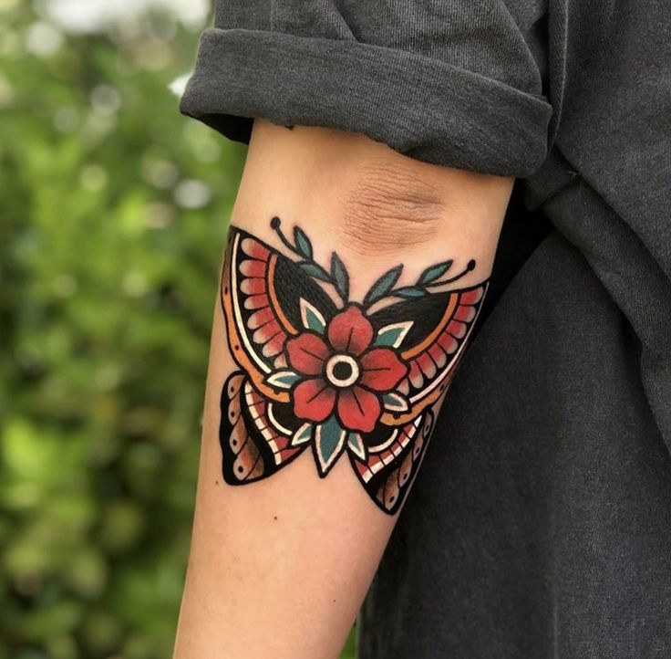 a person with a butterfly tattoo on their arm