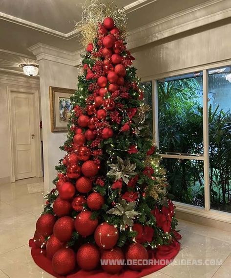 a christmas tree decorated with red balls and greenery