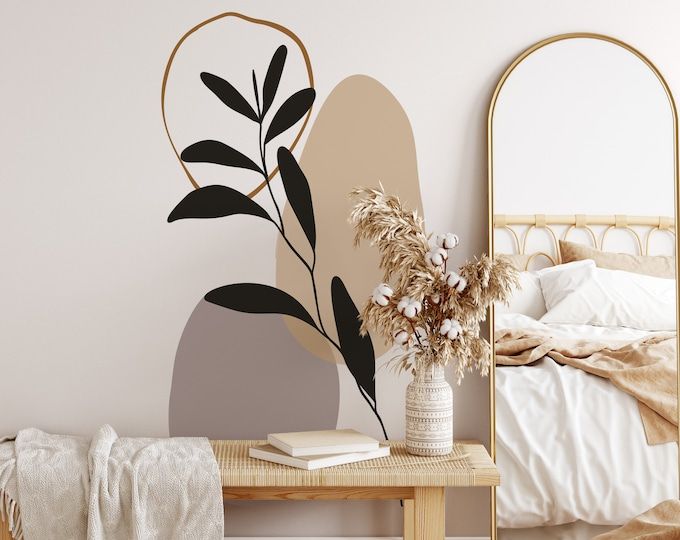 a bedroom with a bed, mirror and plant on the table in front of it